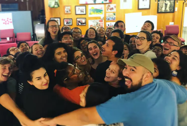 Organizers huddled together in a group embrace