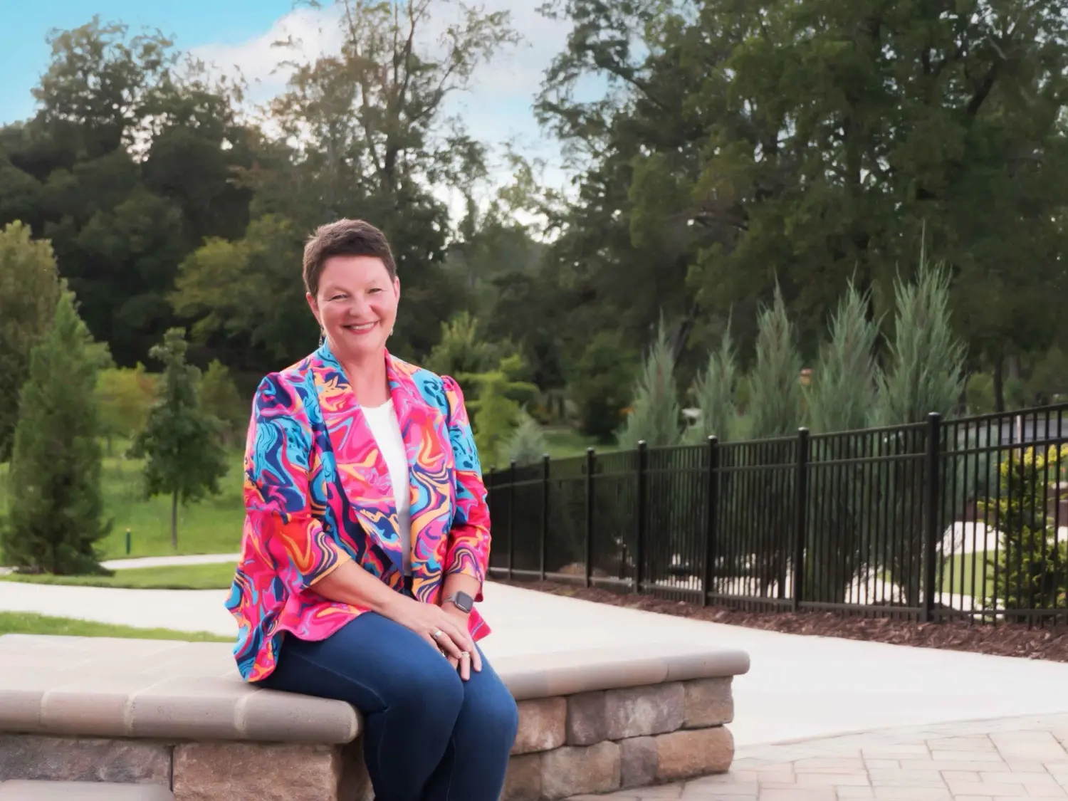 Beth Kennett photographed for the campaign, seated in a Burlington park