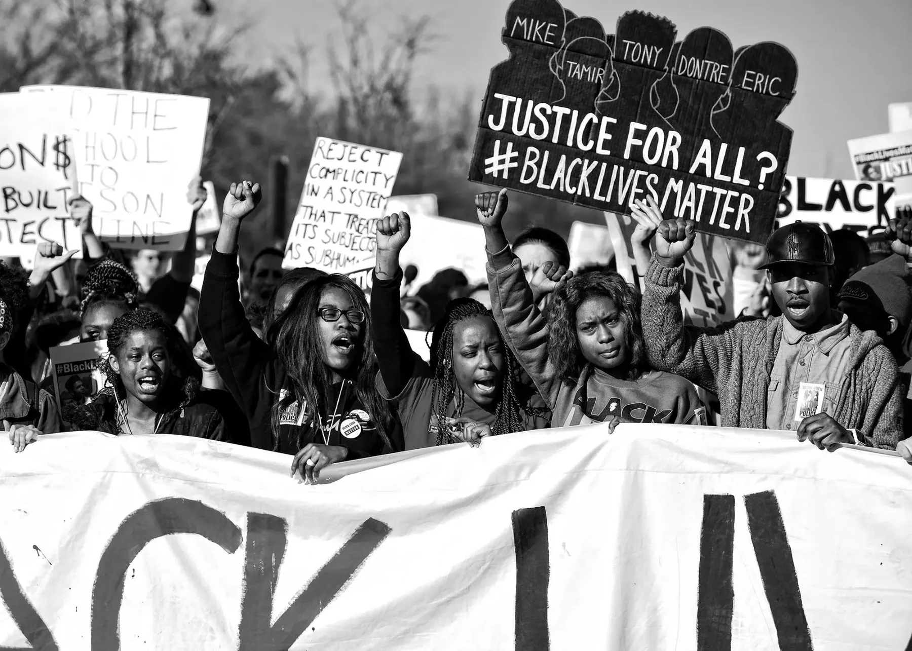Organizers marching with protest signs